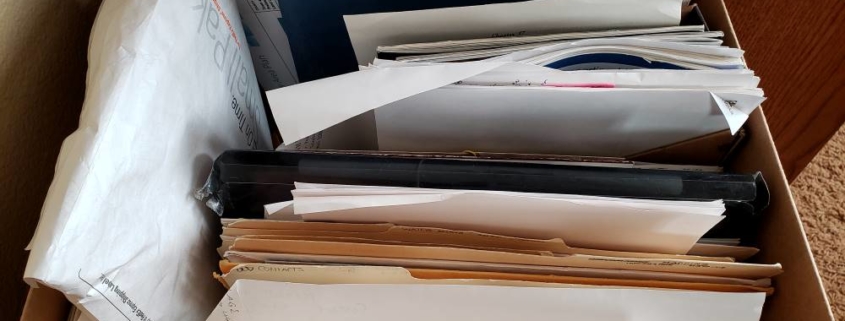 Piles of overwhelming paperwork stored in box